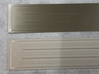 Close-up on large Ni nozzle-plates, micropatterned conical spray orifices